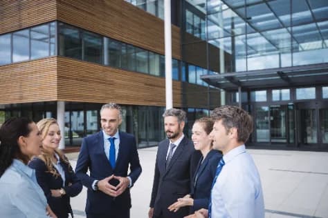 Team outside an office building